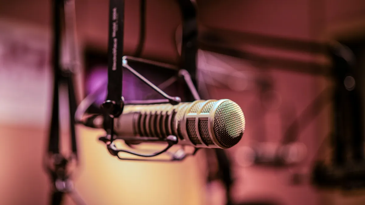 A podcast microphone in purple light