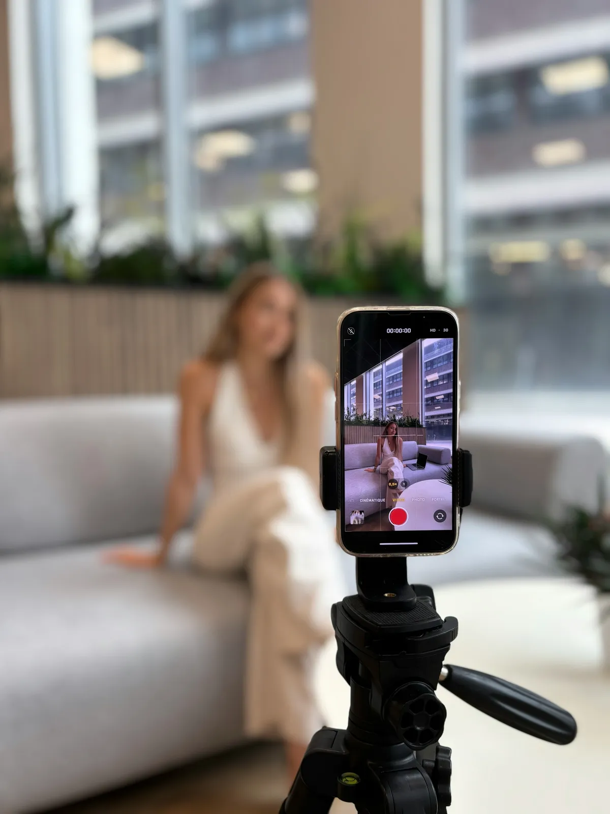 A phone on a stand recording a vertical video
