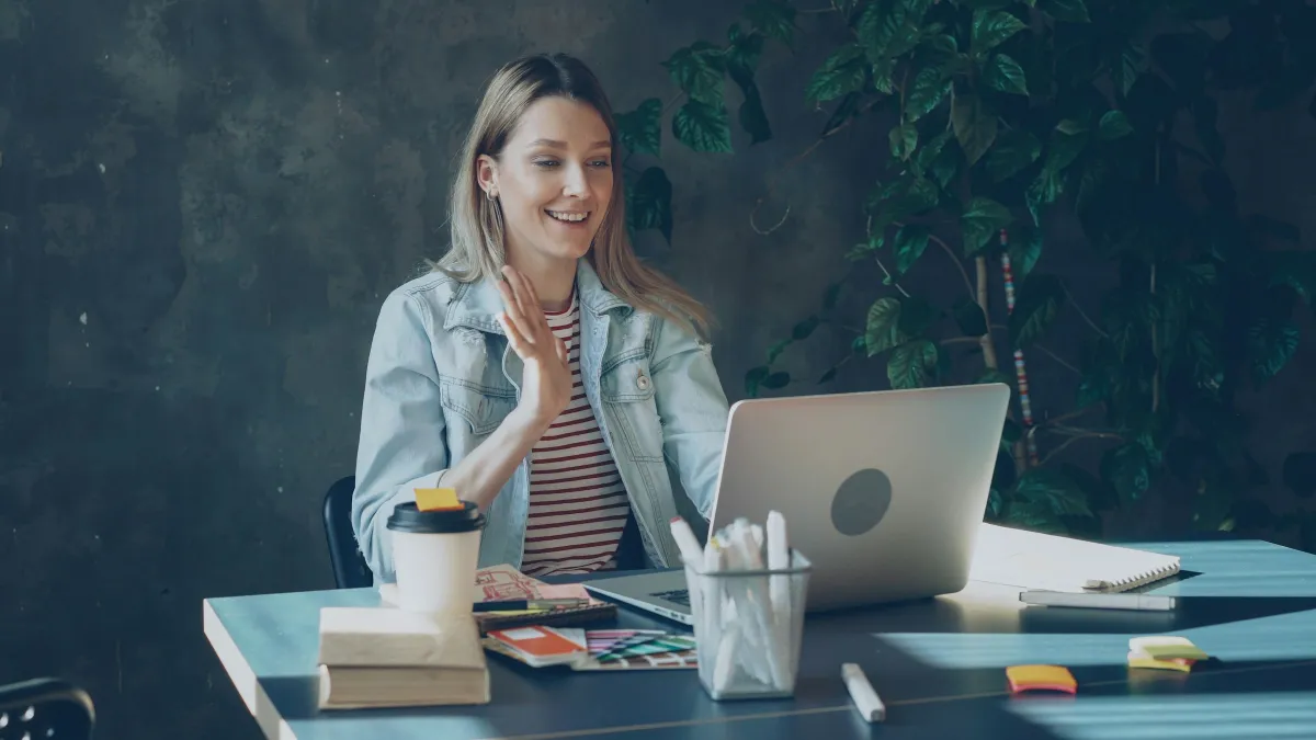 A woman on a video call at her laptop